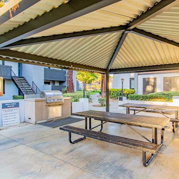 a patio with picnic tables and a grill outside of a building at metro 3610, california