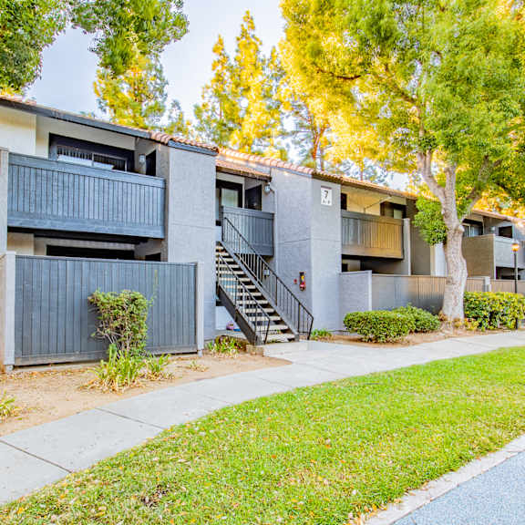 exterior view of an apartment building with a sidewalk and trees at metro 3610, california