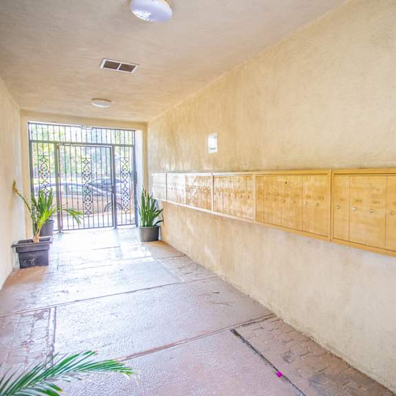 a long row of wooden cabinets on the wall of a building