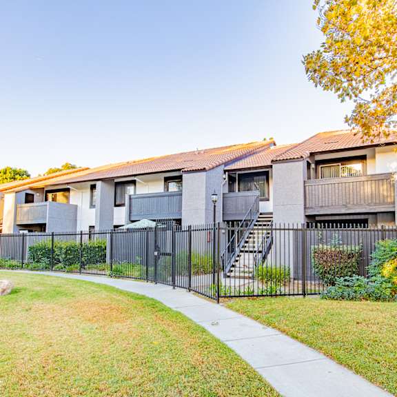 a modern apartment building with a black fence and a sidewalk at metro 3610, riverside, 92505