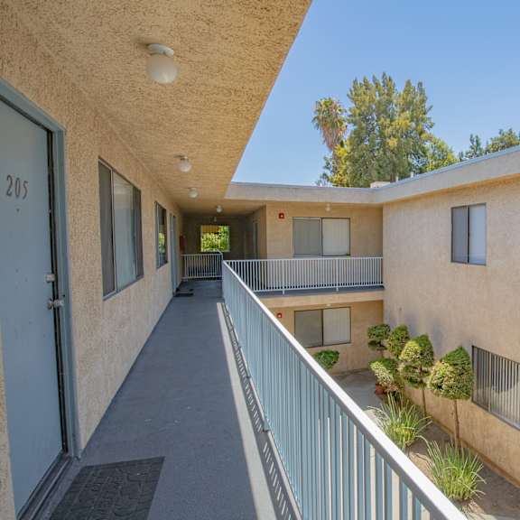 the outlook of a building with a long balcony and a courtyard