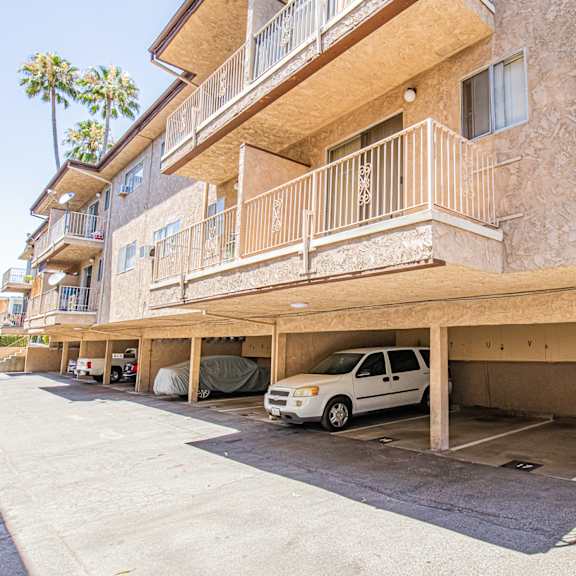 an apartment building with a car parked in a parking garage