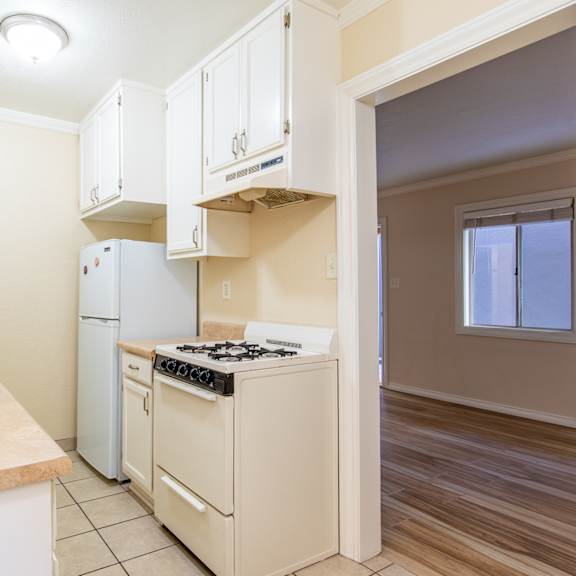 a kitchen with a stove and a refrigerator and a sink