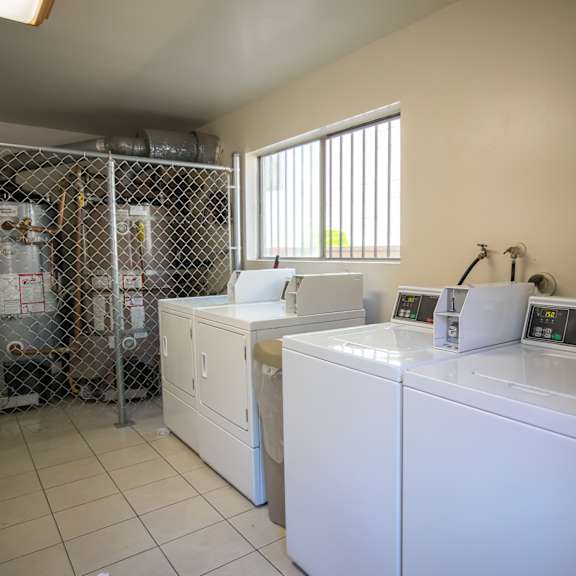 a laundry room with washers and dryers and a shower