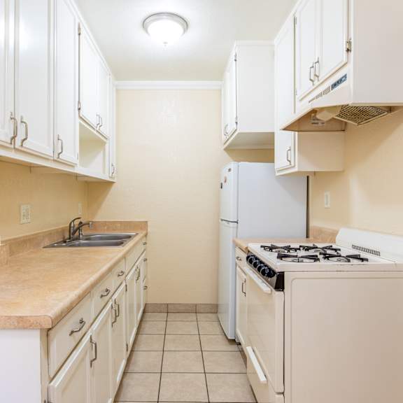 a kitchen with white appliances and white cabinets