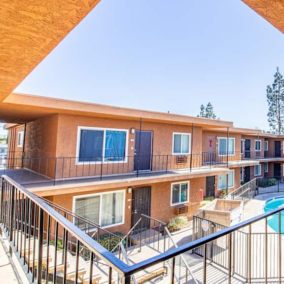 a view of a pool from a balcony of a building.