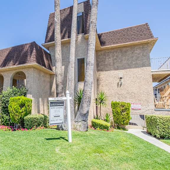 a house with a sign in front of a lawn