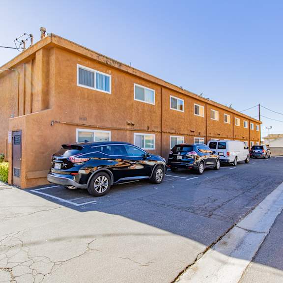 a large brick building with cars parked in front of it