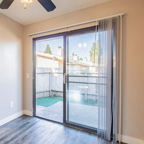 an empty kitchen with sliding glass doors to a backyard pool