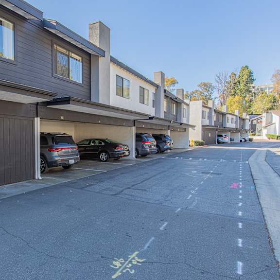 a parking lot with cars parked in front of a building