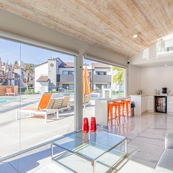 a living room with a glass table and a pool