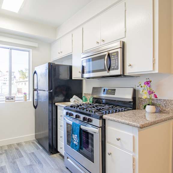 a kitchen with stainless steel appliances and white cabinets