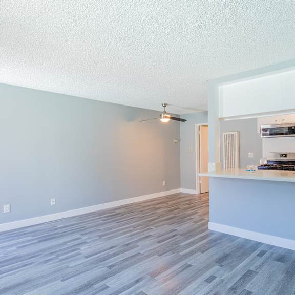 an open living room and kitchen with a counter top and