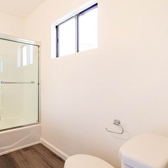 a bathroom with a toilet sink and a shower
