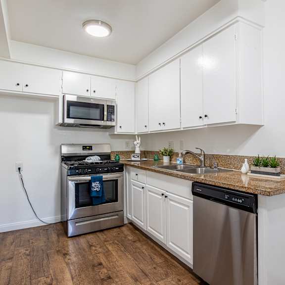 a kitchen with a stainless steel dishwasher and oven.