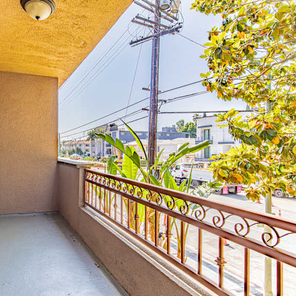a balcony with a metal railing and a window.