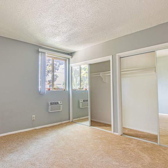 a room with a carpeted floor and a window.