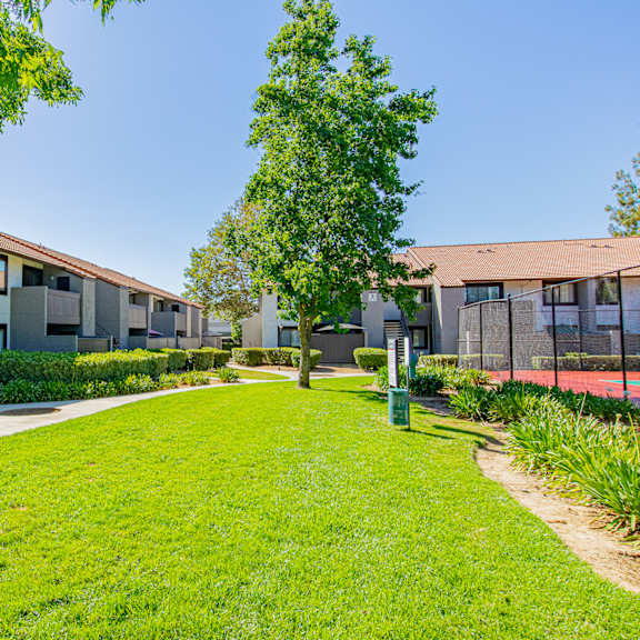 a green lawn leads to a building with a brown roof at metro 3610, riverside, 92505