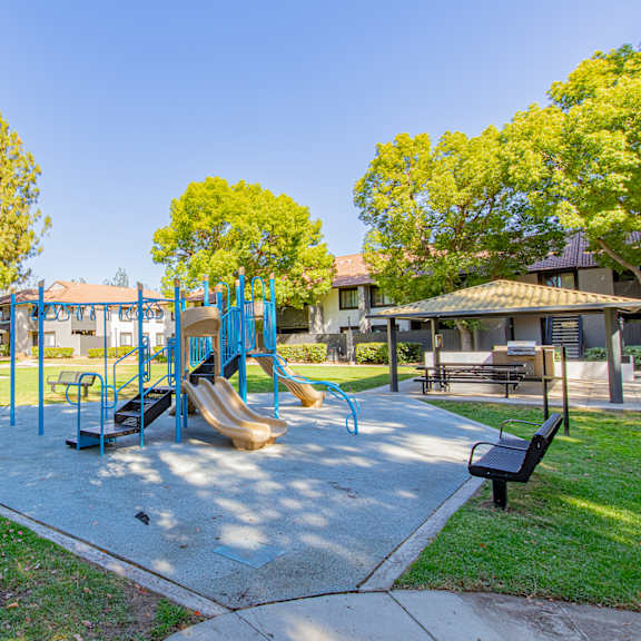 a playground with a blue slide and a yellow slide at metro 3610, riverside, 92505
