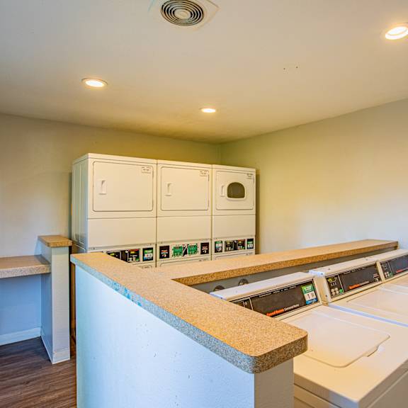 a laundry room with a washer and dryer stacked on top of each other at metro 3610, riverside, 92505