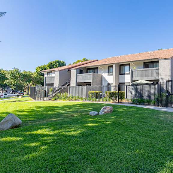 a row of houses with a green lawn in front at metro 3610, riverside, 92505