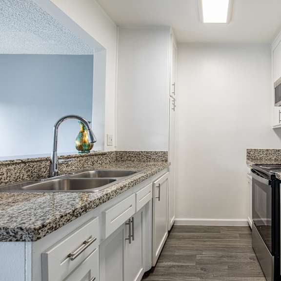 a kitchen with granite countertops and stainless steel appliances.