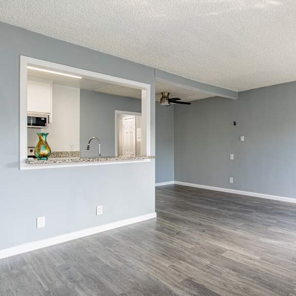 a room with a grey wall and a wooden floor.