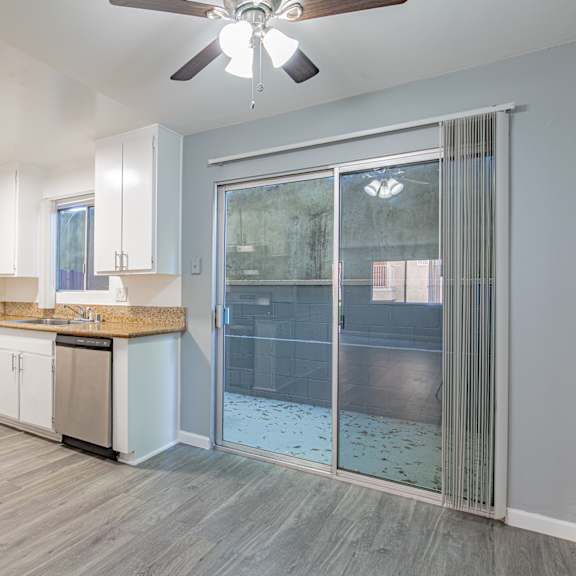 a modern kitchen with a fan on the ceiling.