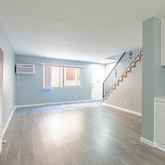 a room with a staircase and cabinets.
