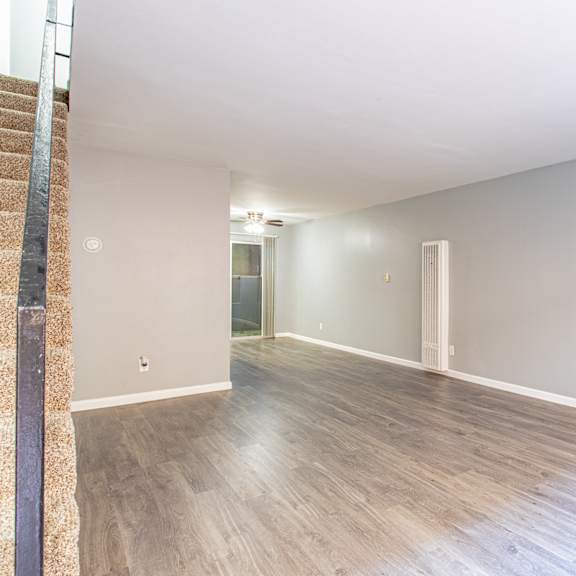 a room with wooden flooring and white walls.