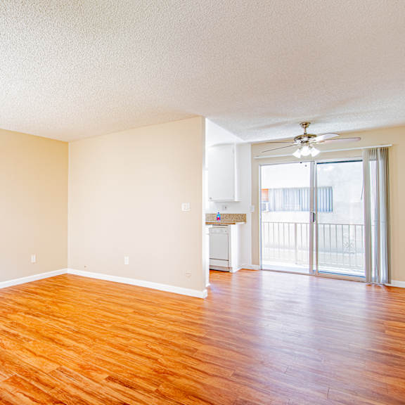 a room with wooden floors and a ceiling fan.