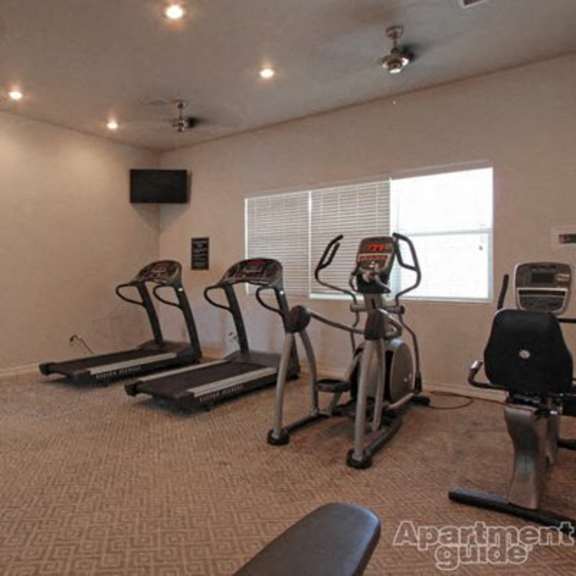 a gym with exercise equipment and a window