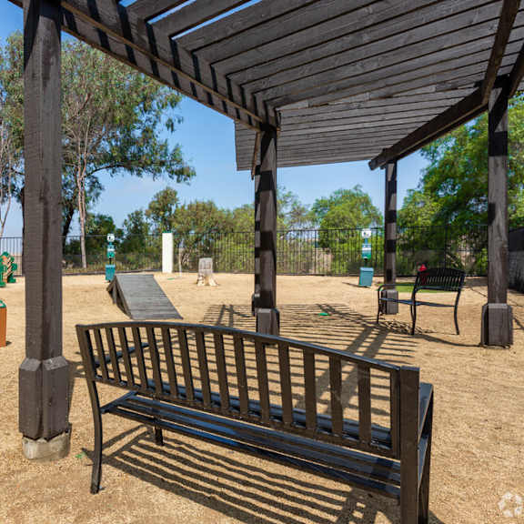 a park bench and a pavilion in a park