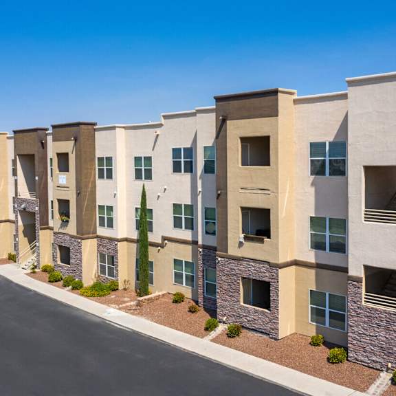 an apartment building with a street in front of it
