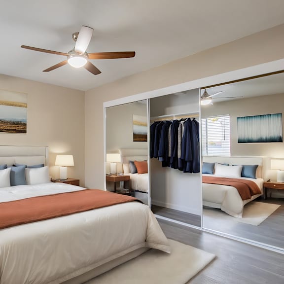 a bedroom with a large bed and a ceiling fan at sofia apartments, tempe, 85283