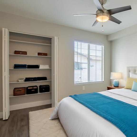 a bedroom with a large bed and a ceiling fan