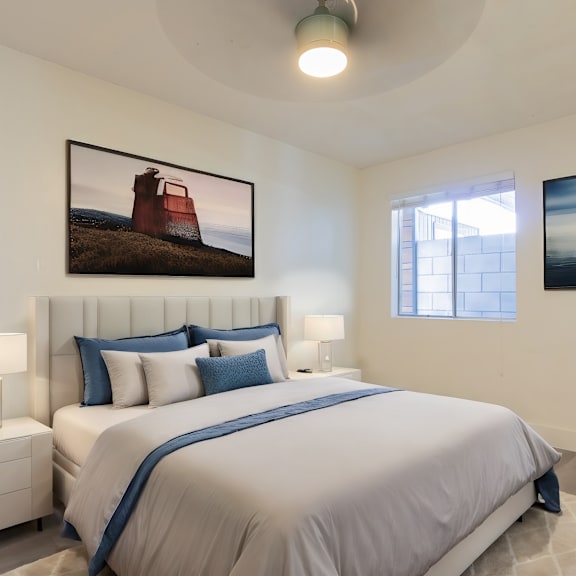 a bedroom with a large bed and two pictures on the wall.