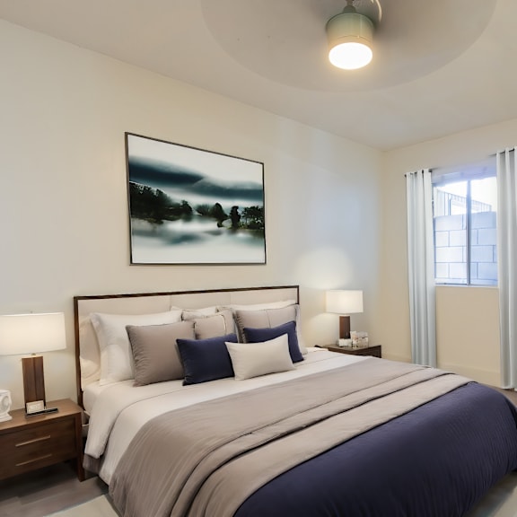 a bedroom with a large bed and two pictures on the wall.