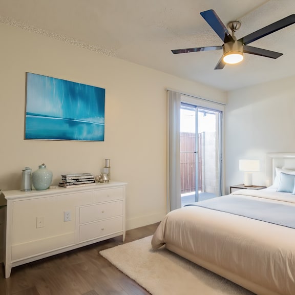 a bedroom with a large bed and a ceiling fan.