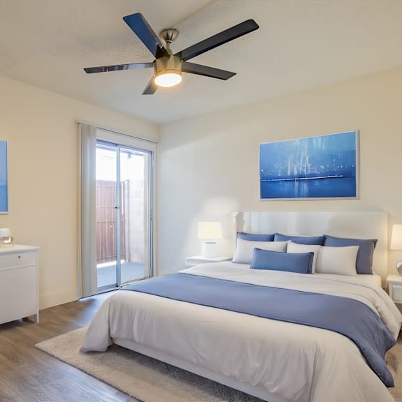 a bedroom with a large bed and a ceiling fan.