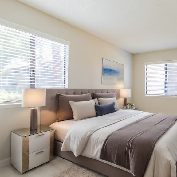 a bedroom with a bed and two windows at metro 3610, california