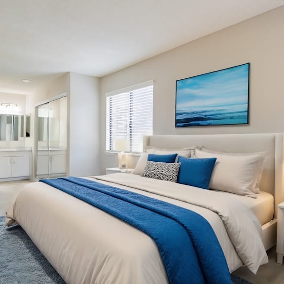 a white bedroom with a large bed and a blue blanket at metro 3610, california