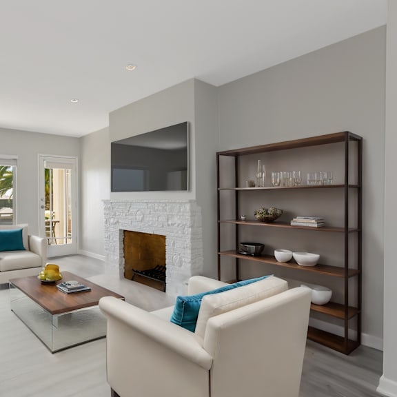 a modern living room with a fireplace and a flat screen tv.