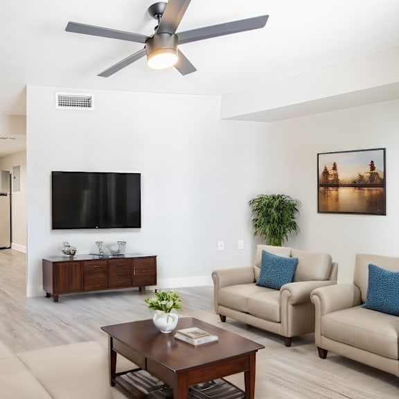 a living room with couches and a table with a tv