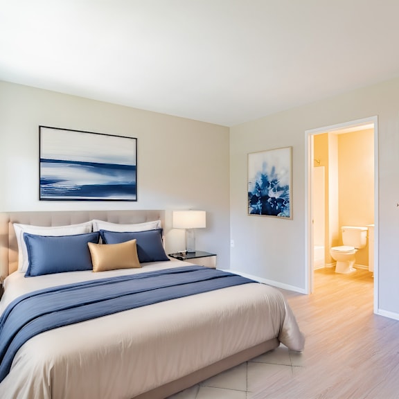 a bedroom with a bed and a closet and a bathroom
