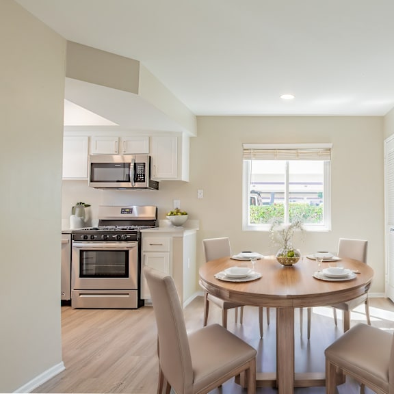 a living room with a table and chairs and a washing machine and a washer