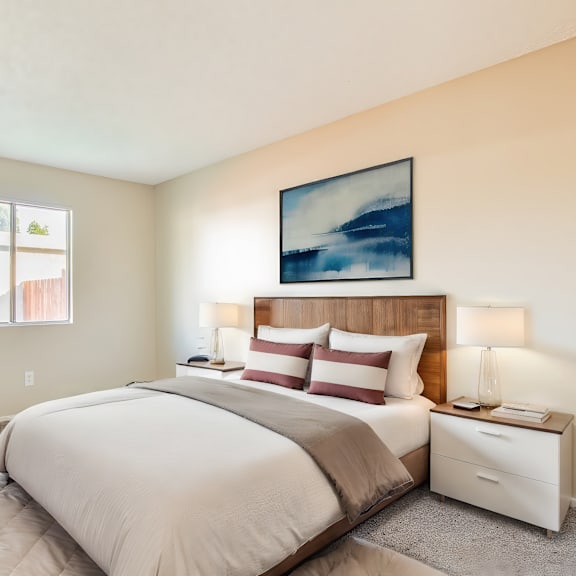 a bedroom with a bed and two windows