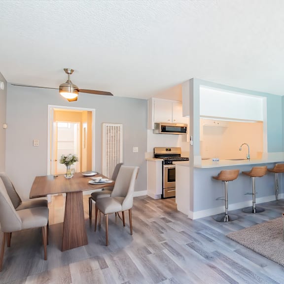 a modern living room with a dining table and chairs.