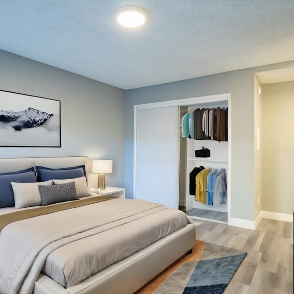 a bedroom with a large bed and a painting above it.