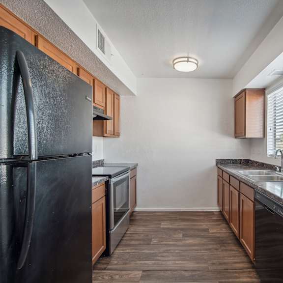 the kitchen of our studio apartment atrium with stainless steel appliances and wooden cabinets